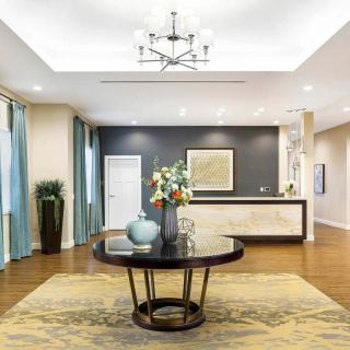 A modern lobby with a central table and elegant decor.