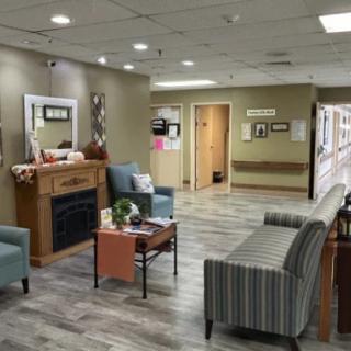 A cozy waiting room with comfortable seating, decorative elements, and warm lighting.