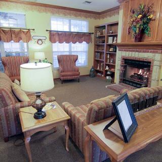 A cozy living room with a fireplace and comfortable seating.