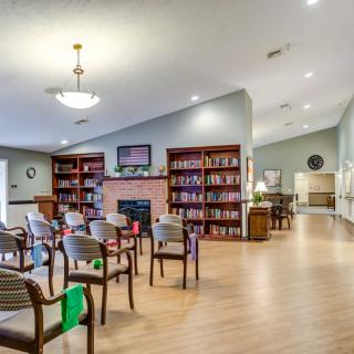 A cozy library with bookshelves and a seating area.