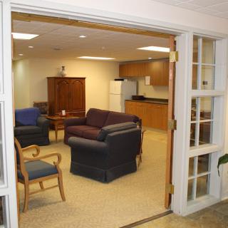 A cozy living area with various seating options and a small kitchenette.