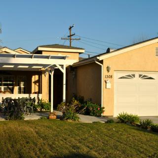 A suburban house with a well-maintained lawn and attached garage.