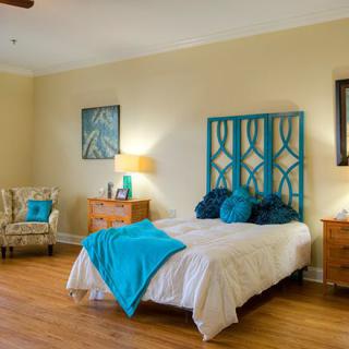 A cozy bedroom with blue accents and modern decor.