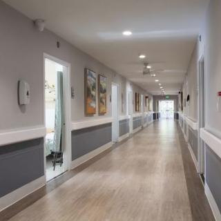 A well-lit hallway with modern decor and artwork on the walls.