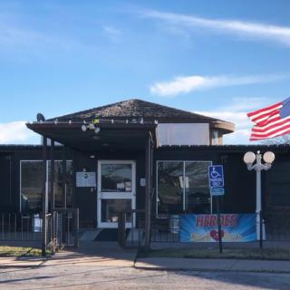 A small restaurant building with an American flag flying outside.