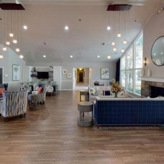 A spacious and modern lounge area with comfortable seating, stylish decor, and ample natural light.