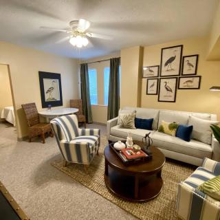 Cozy living room with comfortable seating, elegant decor, and warm lighting.