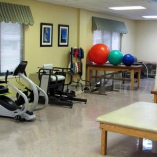 A rehabilitation therapy room with exercise equipment and fitness balls.