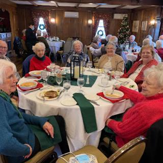 A joyful gathering of seniors enjoying a festive meal together.