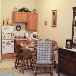 Cozy kitchen and dining area with wooden furniture and appliances.
