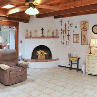 A cozy living room featuring a fireplace, comfortable seating, and decorative wall art.