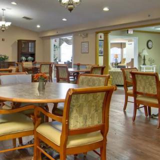 A well-lit dining area with neatly arranged chairs and tables.