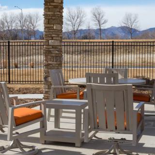 Outdoor patio with furniture overlooking a mountain view.