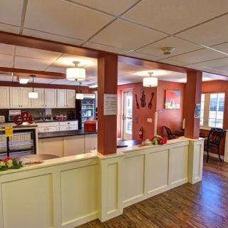 A modern and cozy kitchen and dining area with wood flooring and stylish lighting.