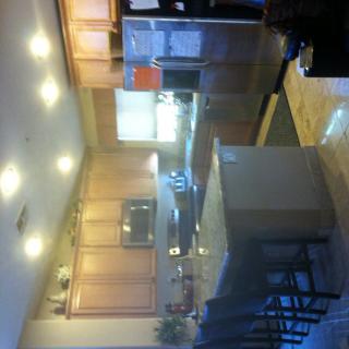 A modern kitchen featuring an island and wooden cabinets.