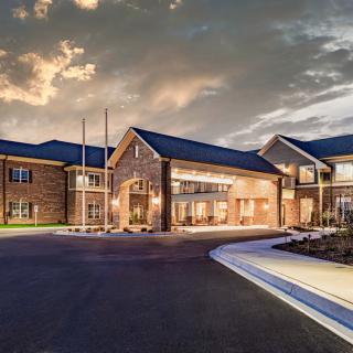 A modern building exterior illuminated at dusk.