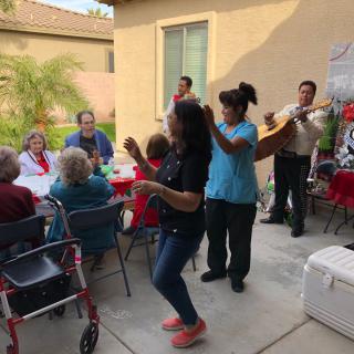 A lively outdoor gathering with people enjoying music and dancing.
