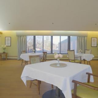 A bright and minimalist dining area with neatly arranged tables by large windows.