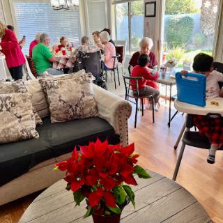 A joyful gathering in a cozy living room with friends and family enjoying each other's company.