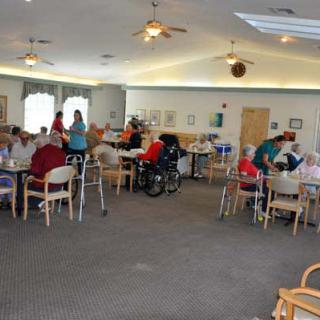 A community room in a nursing home where seniors are gathered for social activities.