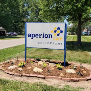 Aperion sign with well-maintained landscaping in a residential area.