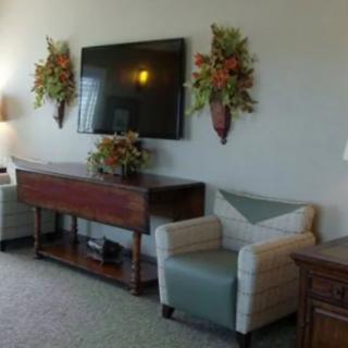 A cozy living room with stylish furniture and wall decorations.