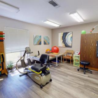 A therapy room equipped with exercise equipment and fitness tools for rehabilitation.