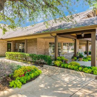 A charming suburban house with a well-maintained garden and pathway.