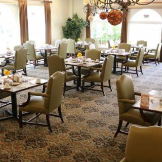 An elegant dining room with neatly arranged tables and chairs.