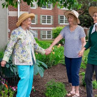Women enjoying time together in a garden.
