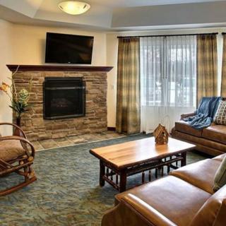 Cozy living room with a stone fireplace and comfortable seating.