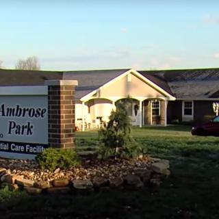 A view of a nursing home facility with a sign reading 'Ambrose Park'.
