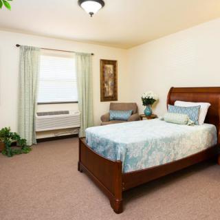 A cozy bedroom with a wooden bed, soft bedding, and tasteful decor.