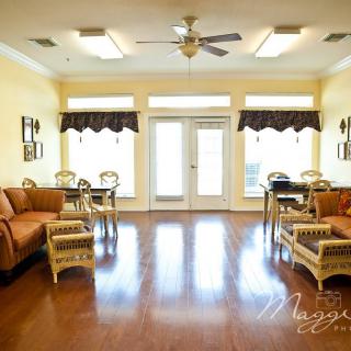 A spacious living room with comfortable seating and ample natural light.