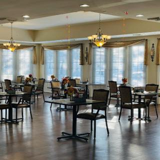 A spacious and elegantly designed dining area with tables and chairs arranged for guests.