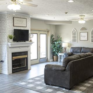 A modern living room featuring a cozy sofa, fireplace, and a wall-mounted television.