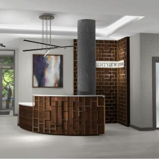 A stylish reception area featuring a curved wooden desk, modern lighting, and decorative artwork.