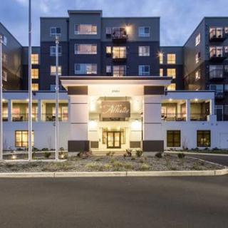 A modern apartment building illuminated at dusk.