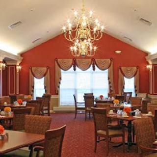 A beautifully designed dining room featuring elegant decor, a chandelier, and comfortable seating arrangements.