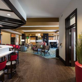 A modern hotel lobby featuring a stylish seating area with contemporary furniture and lighting.