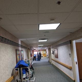 A view of a hospital hallway with medical equipment and overhead lighting.