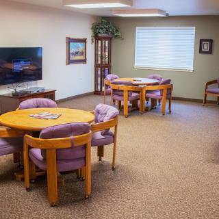 A cozy living room with multiple seating areas and a television.