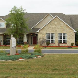 A beautifully designed residential home with a stone facade and well-maintained landscaping.