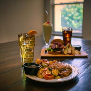 A variety of meals and drinks elegantly arranged on a wooden table.