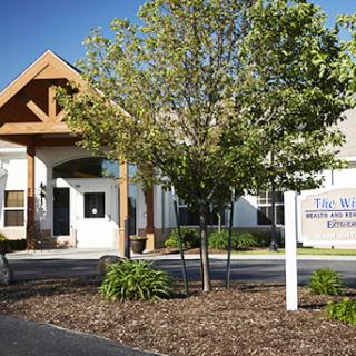 The exterior of a healthcare facility surrounded by greenery.