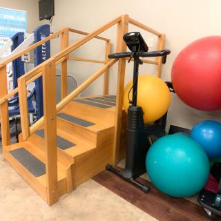 A rehabilitation area featuring therapy stairs and exercise balance balls.