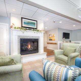A cozy living room with a fireplace and comfortable seating.