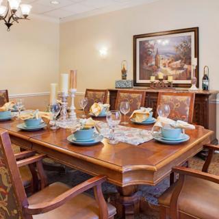 A beautifully set dining room table with elegant decor and artwork.