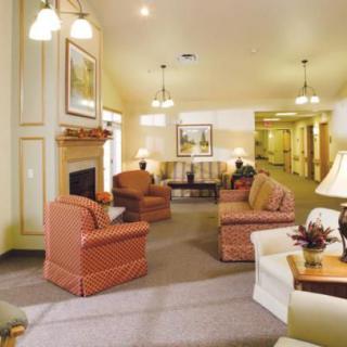 A cozy living room with comfortable sofas, a fireplace, and warm lighting.