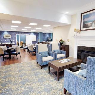 A cozy lobby area with comfortable seating, a fireplace, and elegant interior design.
